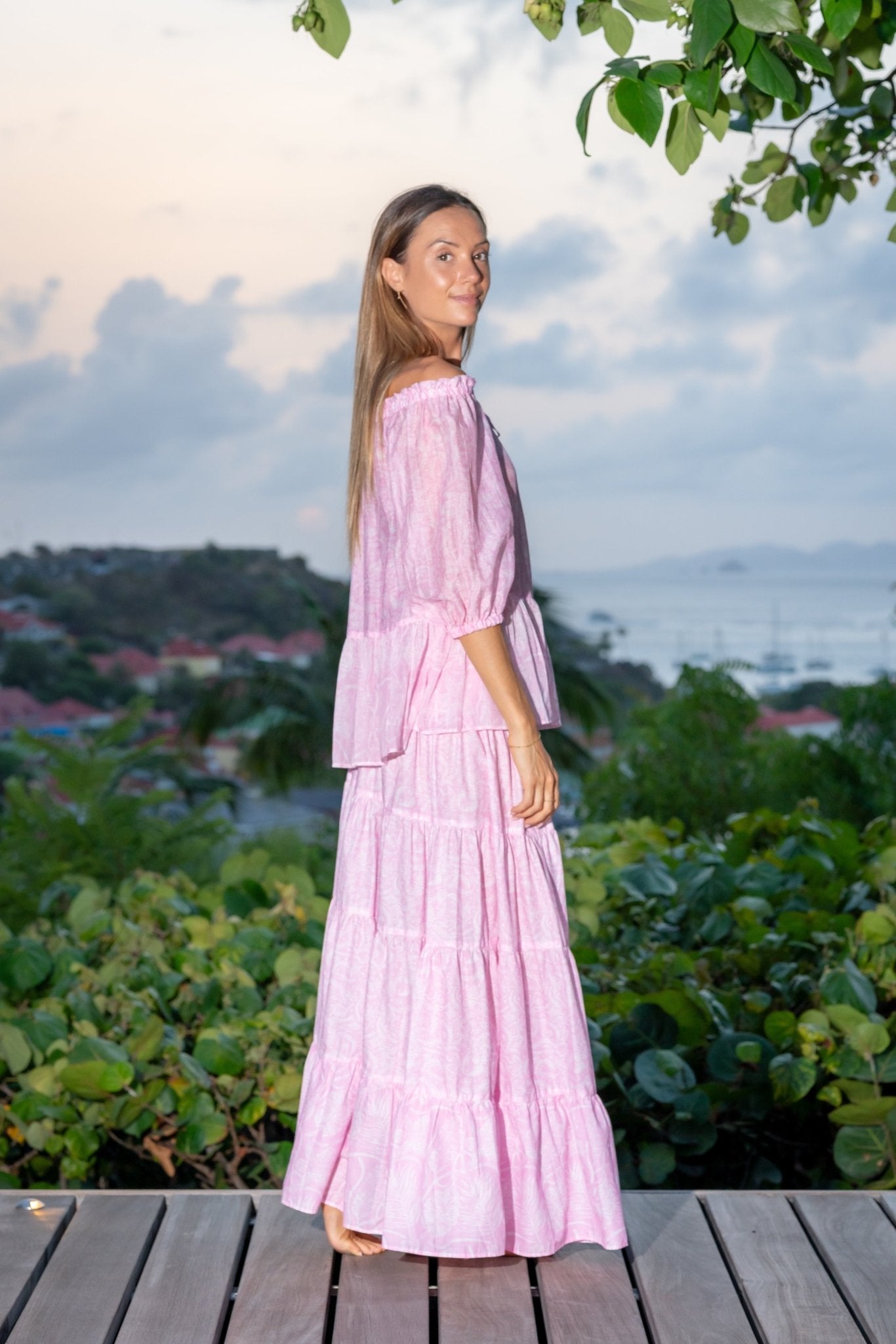 Woman in pink VM print Christy off-shoulder shirt and Kelly long skirt