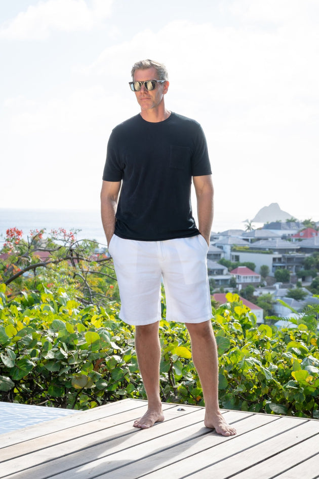 Man in white Valmont linen bermudas on the rocks